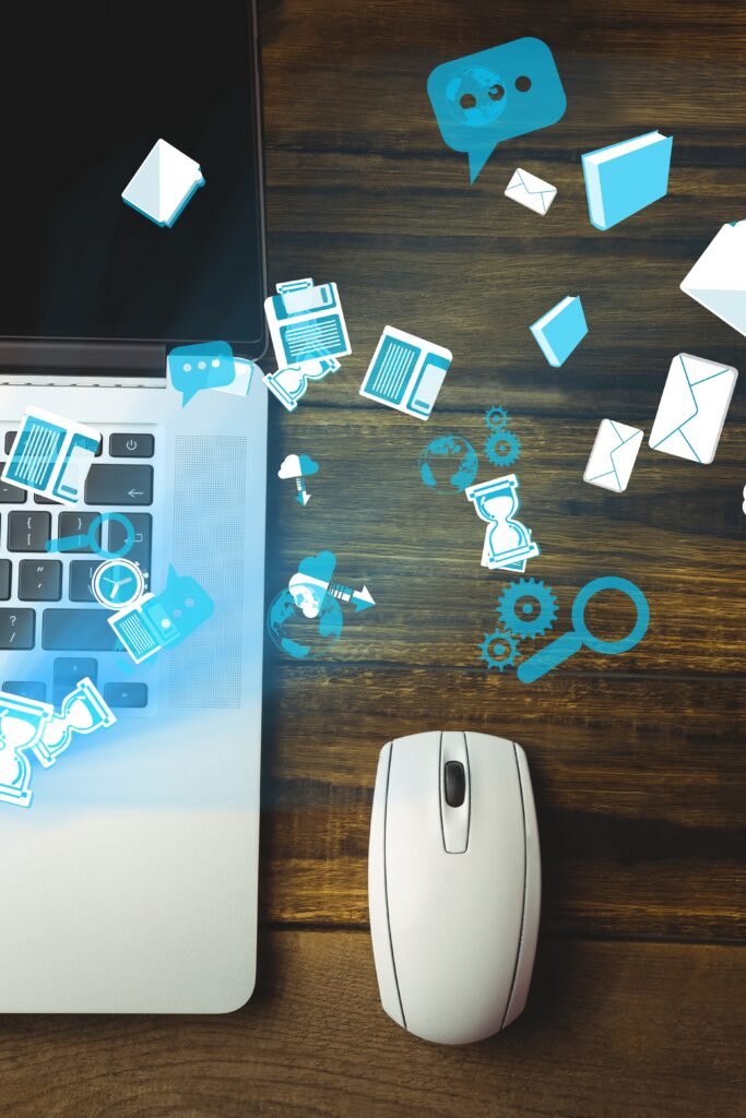 digital composite of mouse and laptop with communication graphics